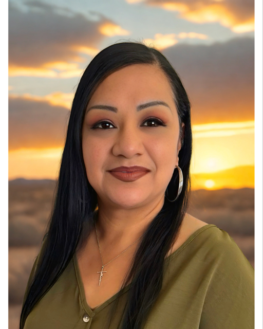 Portrait of Juanita Escalante with an Arizona sunset behind her